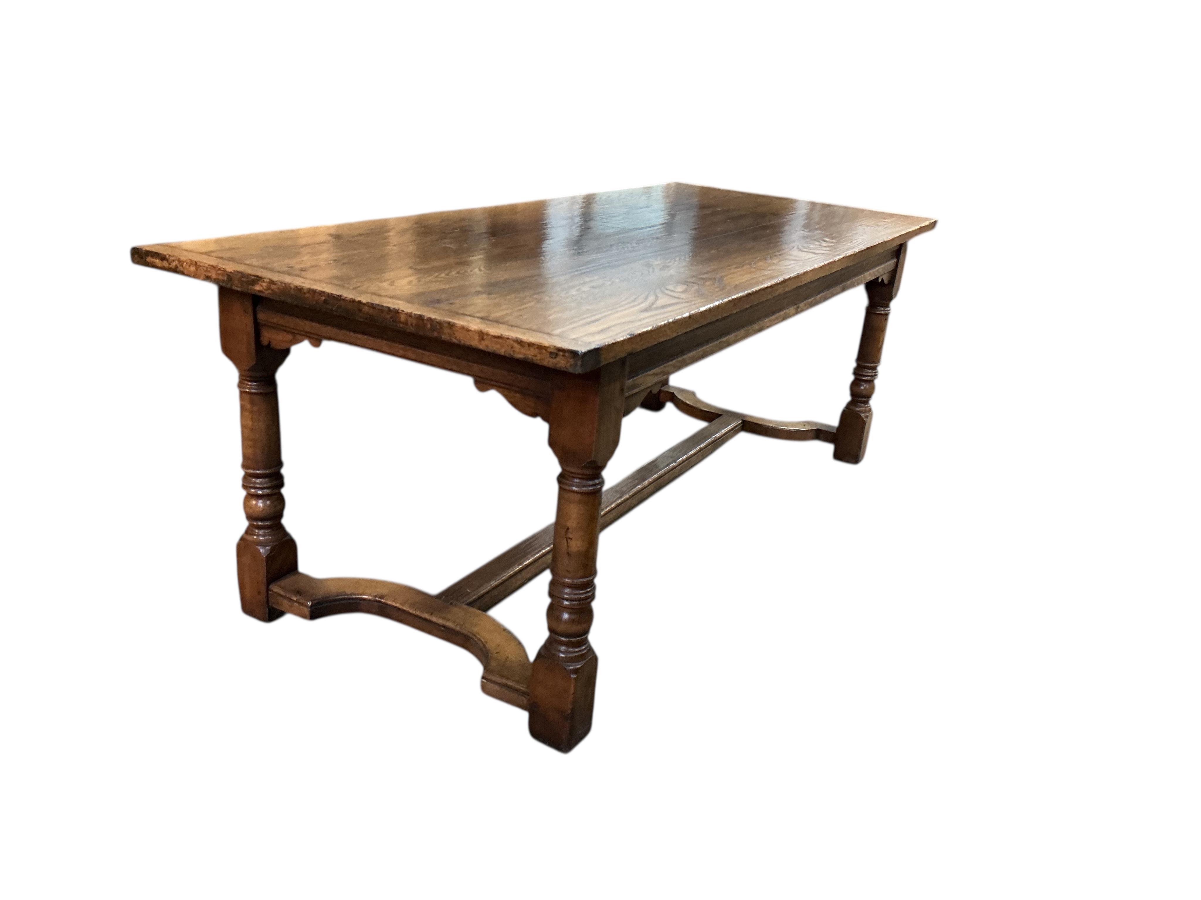 An 18th century style rectangular oak refectory dining table, width 214cm, depth 90cm, height 77cm together with six panelled oak high back dining chairs and two oak elbow chairs